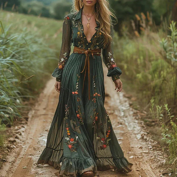 Dark green floral V neck maxi dress with sheer sleeves and brown belt on a model outdoors