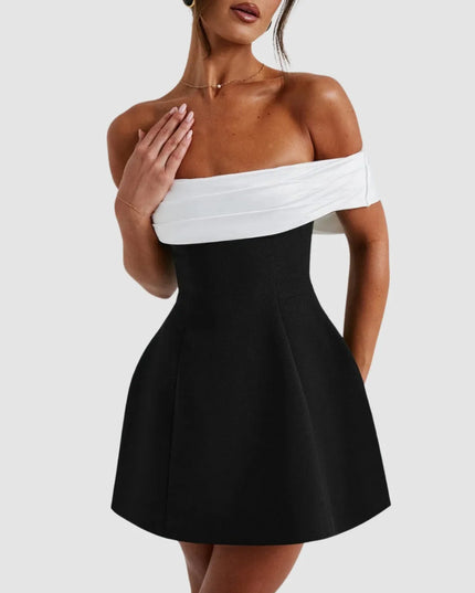 Close-up of off-shoulder Bardot neckline on black and white mini dress
