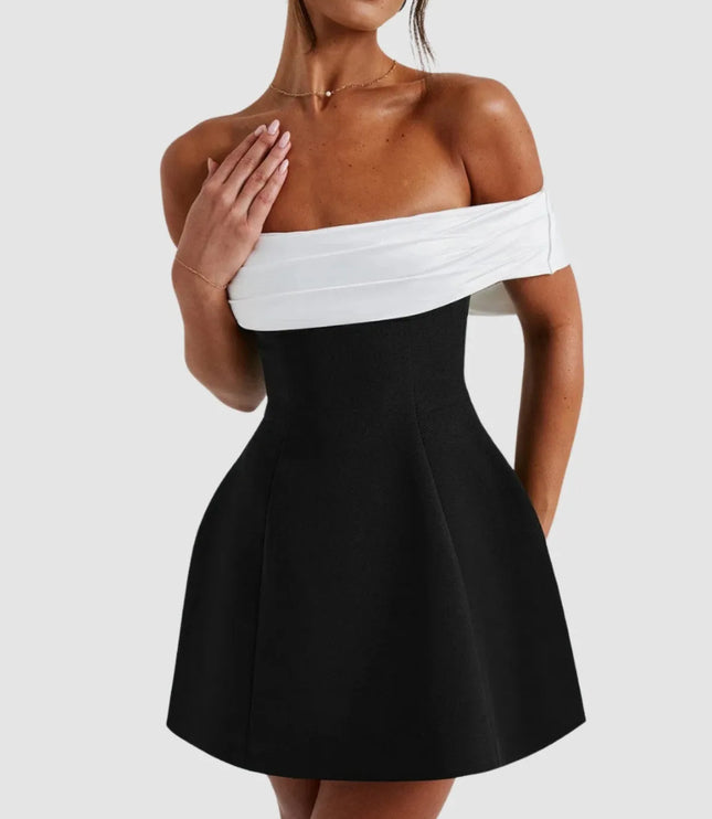 Close-up of off-shoulder Bardot neckline on black and white mini dress