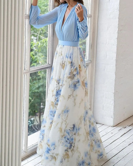 Side view of blue v-neck maxi dress with blue and gold floral print skirt