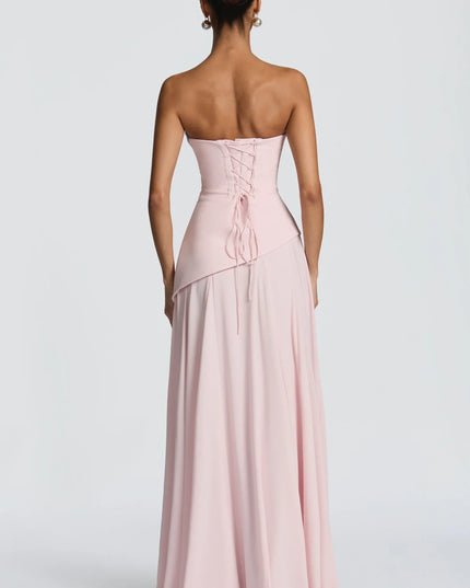 Blush pink strapless maxi dress with lace-up corset back and draped bodice