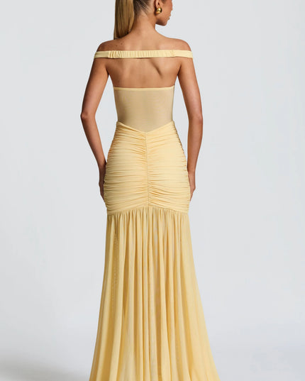 Back view of pale yellow off-shoulder ruched maxi dress with flowing skirt