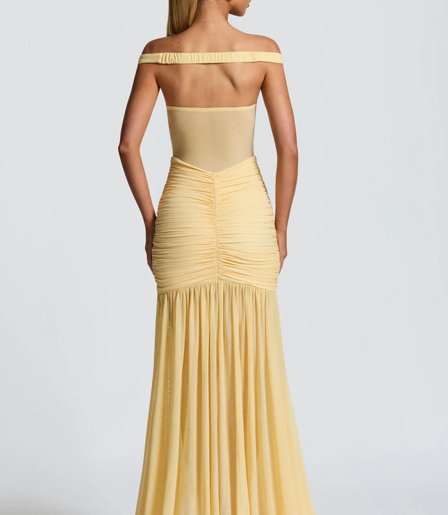 Back view of pale yellow off-shoulder ruched maxi dress with flowing skirt