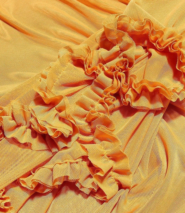 Close-up texture of yellow fabric with orange-toned ruffled trim detail