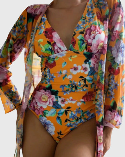Orange floral one-piece swimsuit with long-sleeve wrap, vibrant botanical design