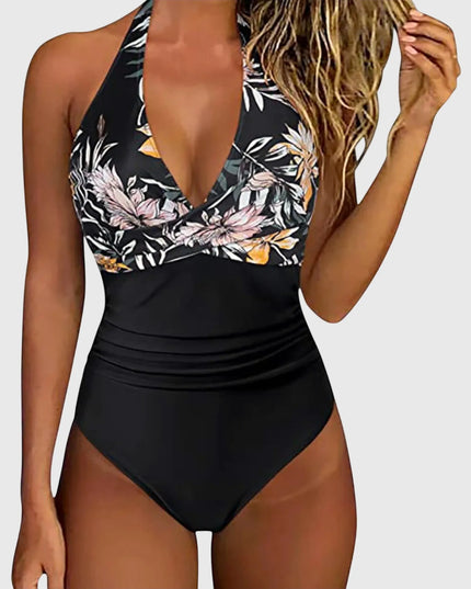 Black halter one-piece swimsuit with pink floral print and solid ruched bottom