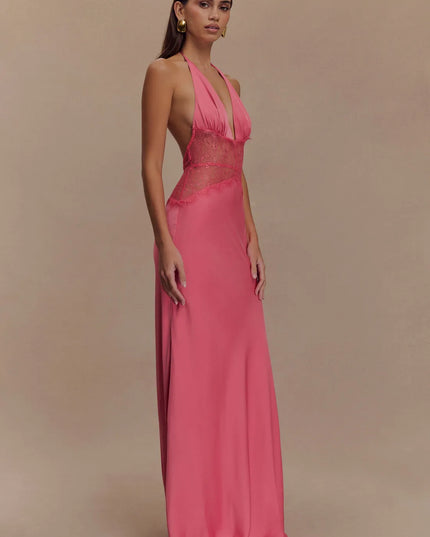 Angled side view pink halter lace maxi dress showing sheer lace midsection and flowy skirt