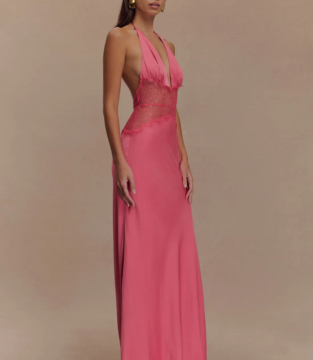 Angled side view pink halter lace maxi dress showing sheer lace midsection and flowy skirt