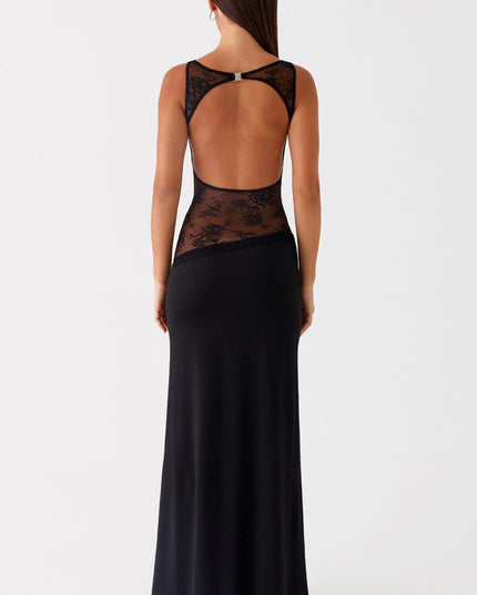 Back view of black maxi dress featuring open lace waist and cross-back straps