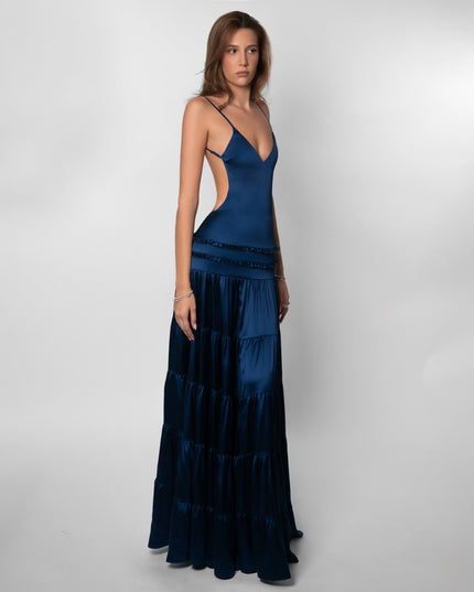 Side view of navy maxi dress showing open back cutout and tiered layers