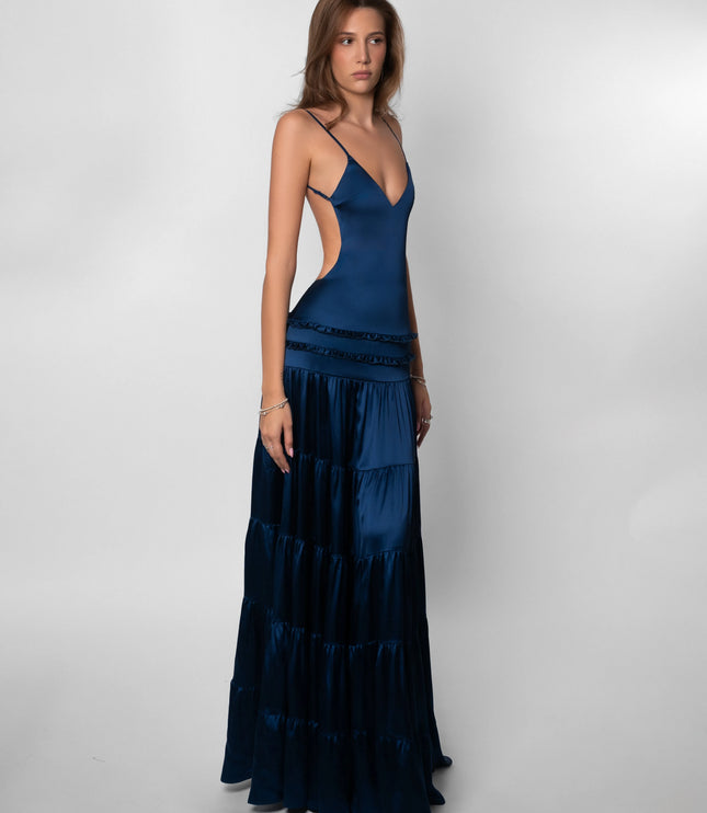 Side view of navy maxi dress showing open back cutout and tiered layers