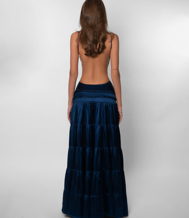 Back view of navy tiered maxi dress with open back design