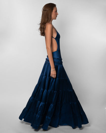 Side profile of navy open back maxi dress with ruffled tiered skirt