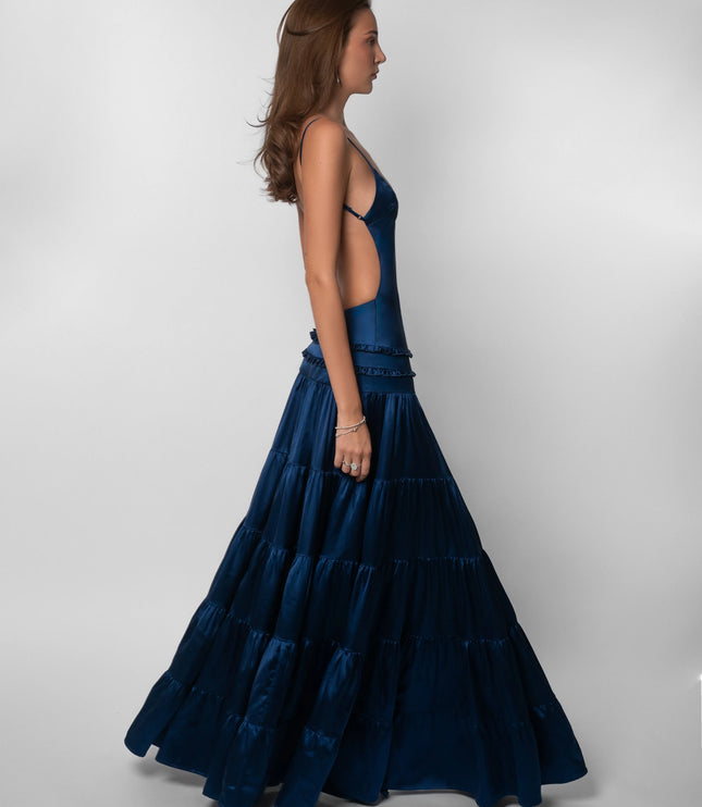 Side profile of navy open back maxi dress with ruffled tiered skirt