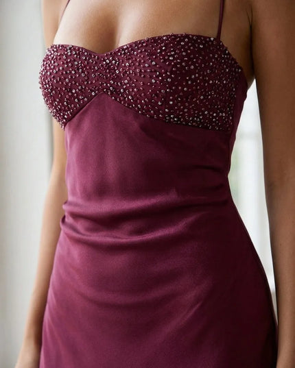 Close-up of burgundy beaded halter maxi dress bodice with sweetheart neckline and shimmering embellishment