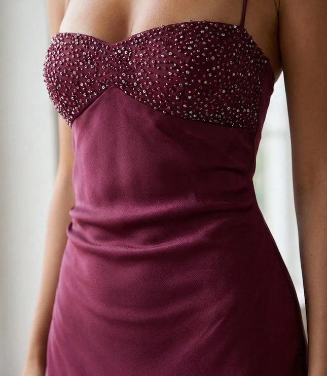 Close-up of burgundy beaded halter maxi dress bodice with sweetheart neckline and shimmering embellishment