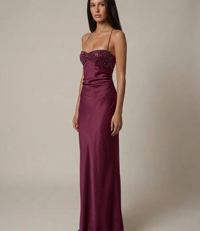 Front view of burgundy beaded halter maxi dress with satin skirt and fitted column silhouette