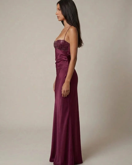 Side view of burgundy halter maxi dress with sparkling beaded bust and smooth satin finish