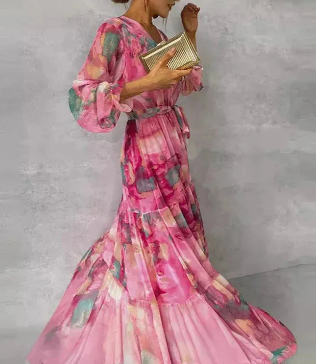 Side profile of pink floral maxi dress showing puffed sleeve detail and layered skirt