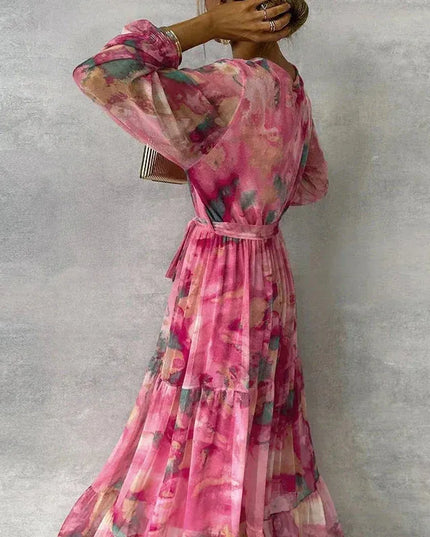 Back view of pink floral maxi dress with puffed sleeves and tiered hem