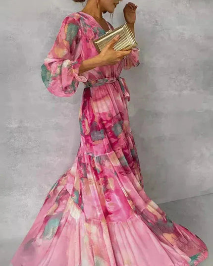 Side profile of pink floral maxi dress showing puffed sleeve and layered skirt