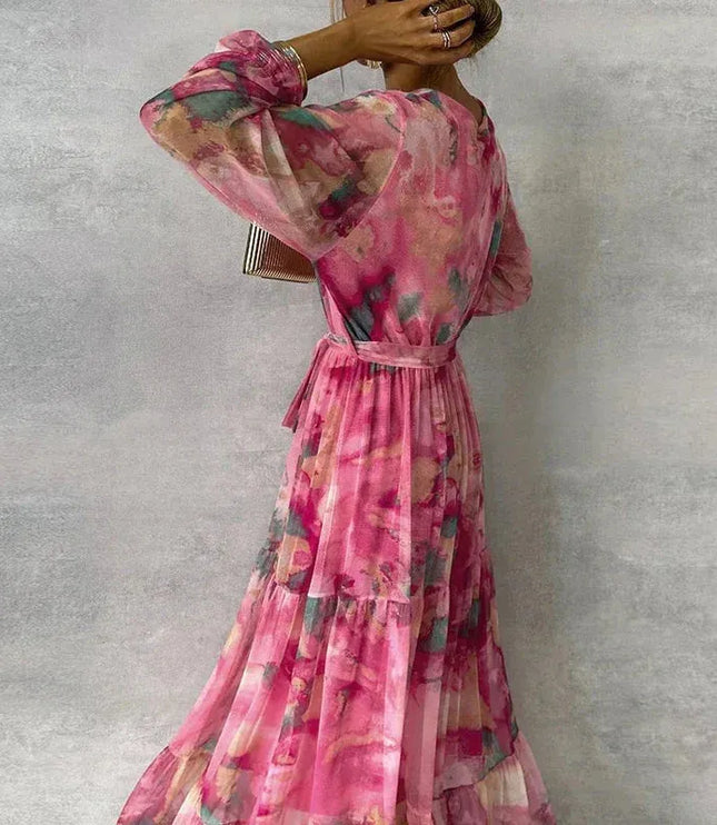 Back view of pink floral maxi dress with puffed sleeves and tiered hem