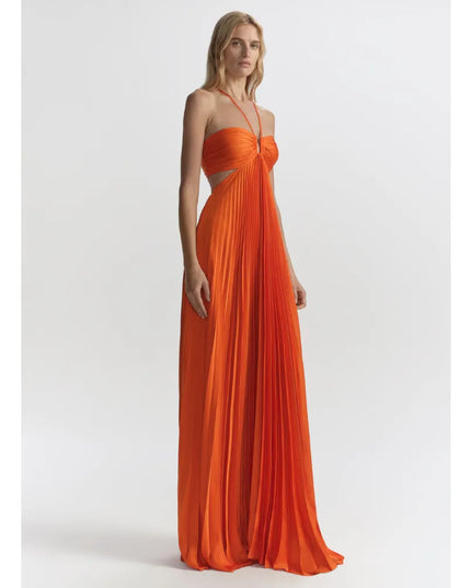 Front view of orange halter maxi dress with ruched bodice and flowing pleats
