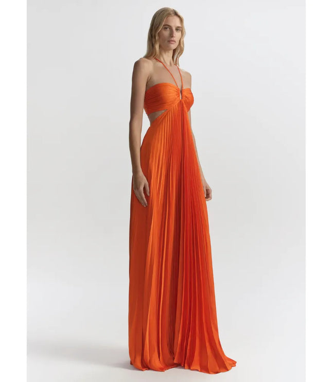 Front view of orange halter maxi dress with ruched bodice and flowing pleats