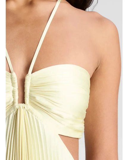 Side view of pale yellow halter maxi dress with ruched bust and flowing pleats
