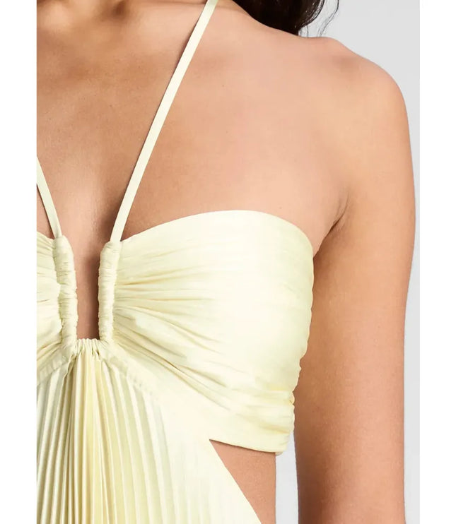 Side view of pale yellow halter maxi dress with ruched bust and flowing pleats