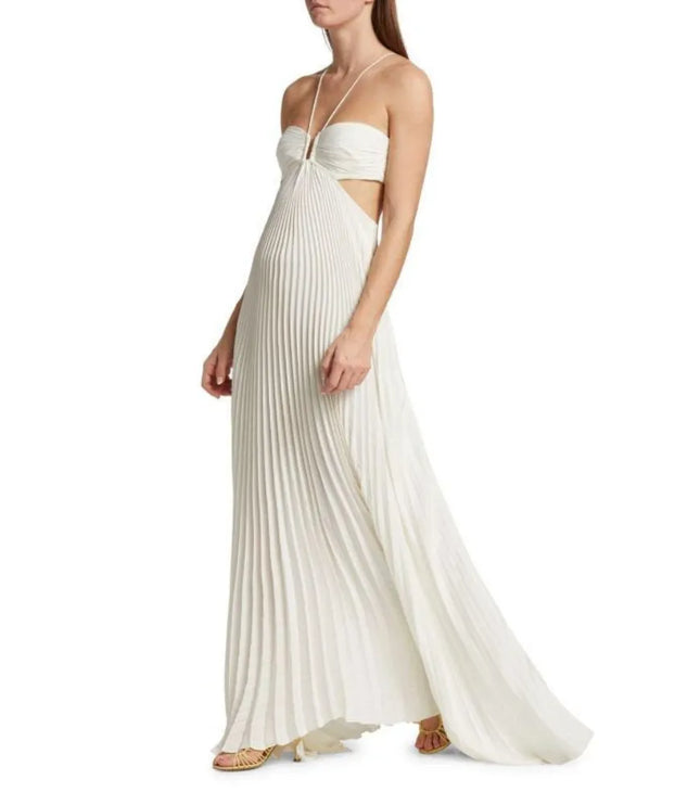 Side view of ivory women maxi halter party dress with pleated skirt and cutout detail