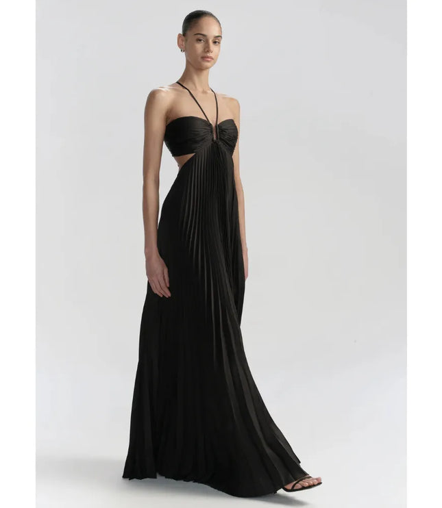 Front view of black maxi halter party dress with pleated skirt, side cutouts, and fitted bodice