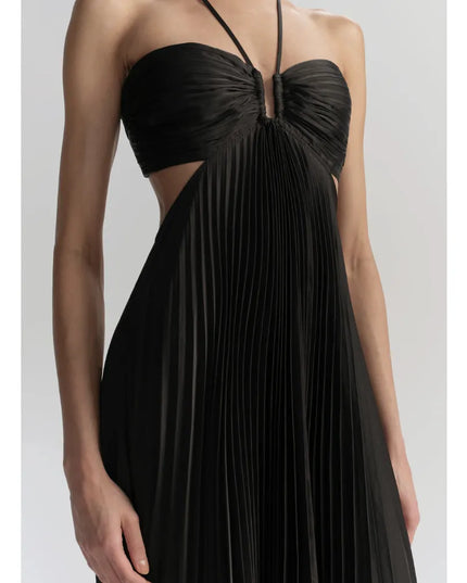 Close-up of black halter maxi dress showing ruched bust, center keyhole, and side cutout detail