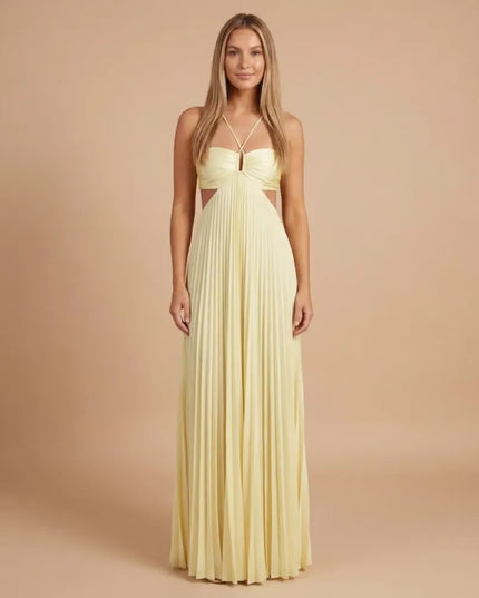 Front view of pale yellow pleated halter maxi dress with cutout waist and crisscross straps