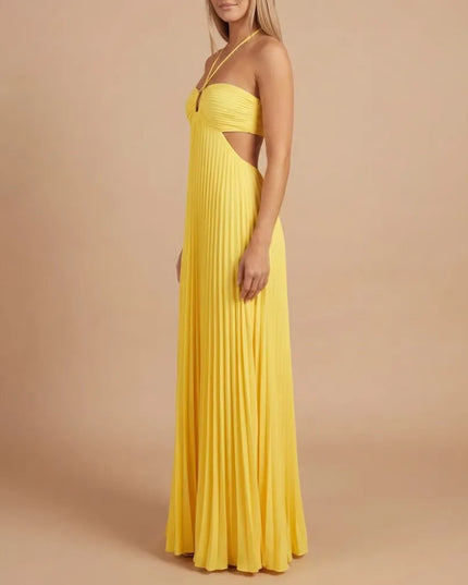 Side view of bright yellow pleated halter maxi dress showing fitted bodice and waist cutout