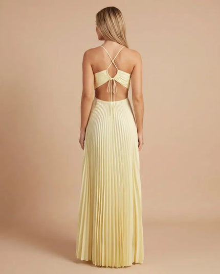 Back view of pale yellow pleated halter maxi dress with open back and tie detail