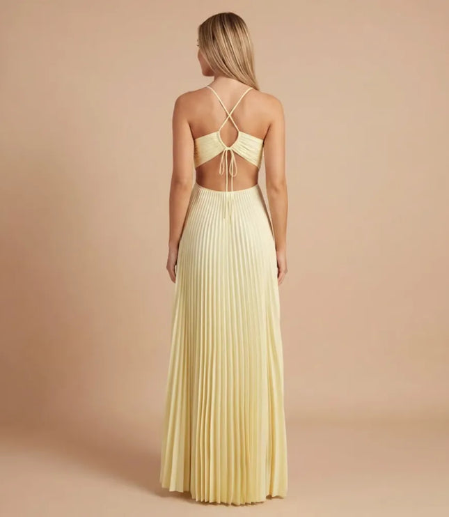 Back view of pale yellow pleated halter maxi dress with open back and tie detail