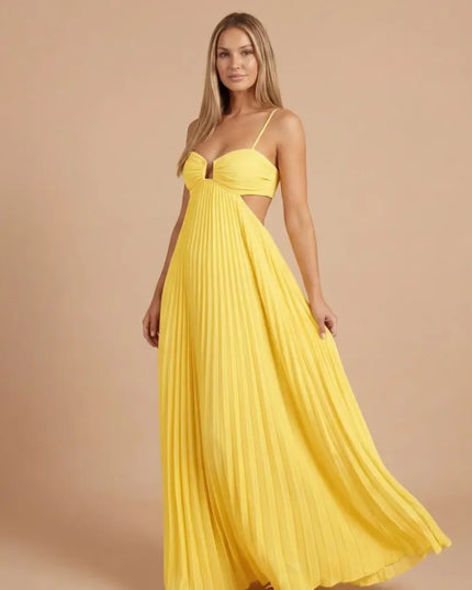 Front angled view of bright yellow pleated halter maxi dress with side cutouts and flowing skirt