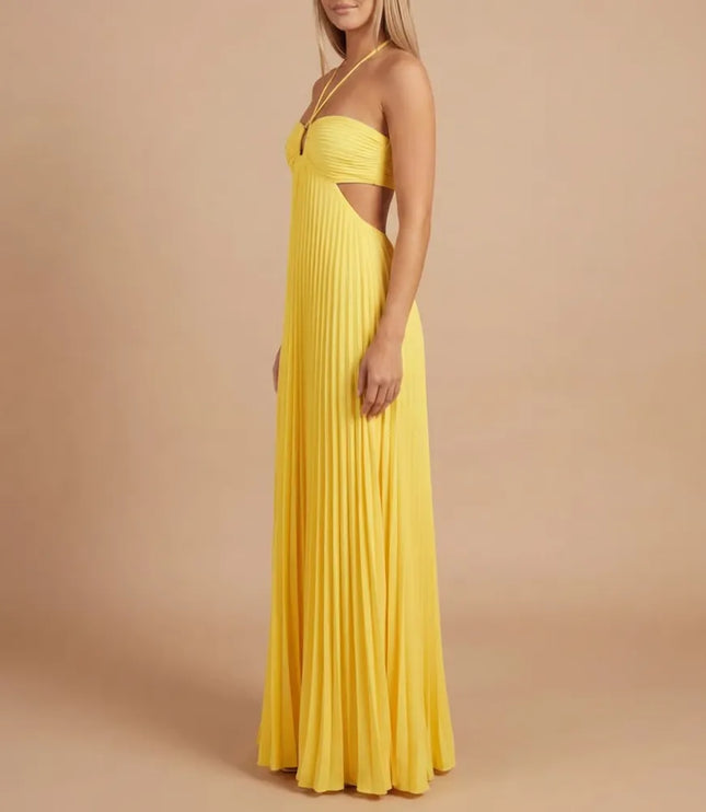 Side view of bright yellow pleated halter maxi dress showing fitted bodice and waist cutout