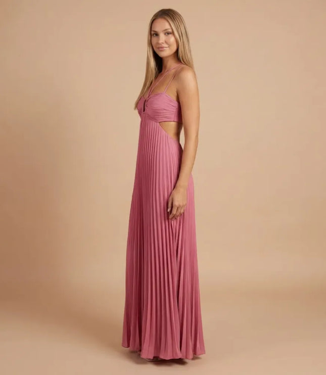 Side angled view of pink pleated halter maxi dress with long flowing skirt and open waist