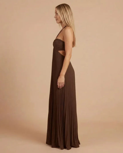 Side view of chocolate brown pleated halter maxi dress showing fit and floor-length pleats