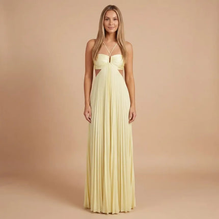 Front view of pale yellow pleated halter maxi dress with cutout waist and crisscross straps