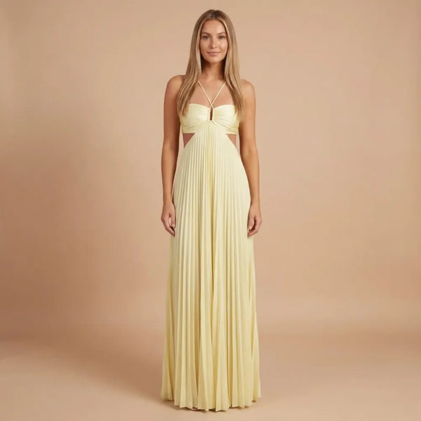 Front view of pale yellow pleated halter maxi dress with cutout waist and crisscross straps