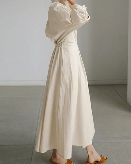 Side profile of cream puffed sleeve wrap dress showing gathered fabric detail