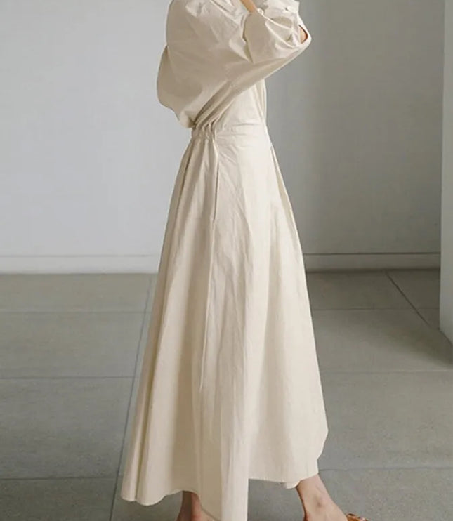 Side profile of cream puffed sleeve wrap dress showing gathered fabric detail