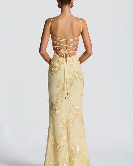 Back view of cream maxi dress with lace-up strappy back and gold embroidery