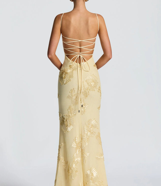 Back view of cream maxi dress with lace-up strappy back and gold embroidery