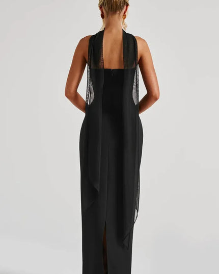Back view of black strapless maxi dress with sheer scarf draping