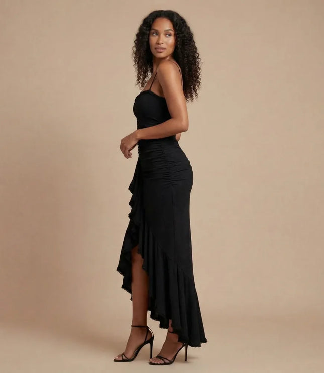 Side view of black spaghetti strap ruched maxi dress with asymmetrical hem