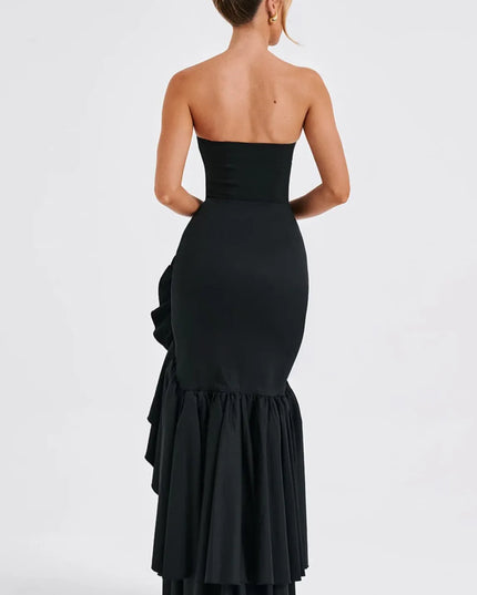 Back view of black strapless maxi dress with layered ruffled slit